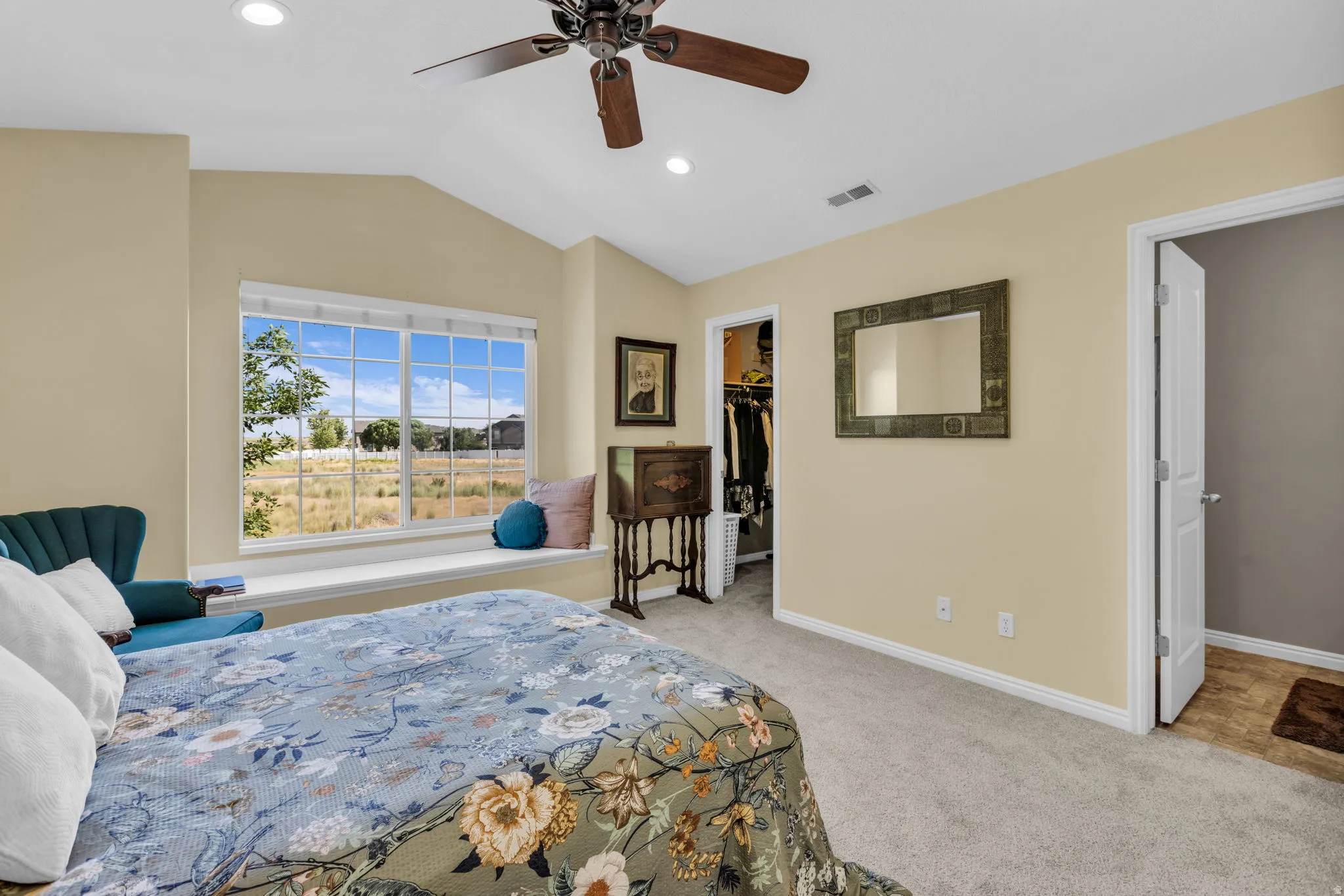Vaulted ceiling room featuring a large window with a built-in window seat, recessed lighting, ceiling fan, and carpet flooring