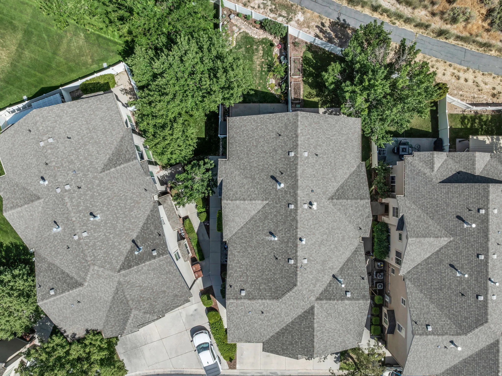 Aerial perspective highlighting residential properties with gray shingle roofing