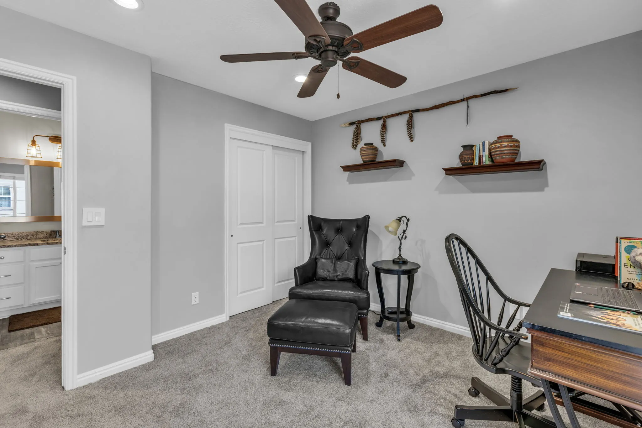 Interior room with soft grey wall paint, grey carpet flooring, a ceiling fan with wood-finish blades, recessed lighting, and white baseboards