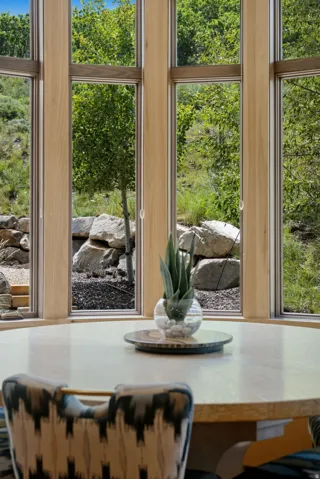 Curved window wall with light wood framing