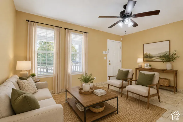 Two large windows with blinds, a ceiling fan with integrated lighting, and light-colored tile flooring