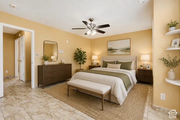 Neutral-toned tile flooring, ceiling fan with integrated lighting, and multiple wall niches