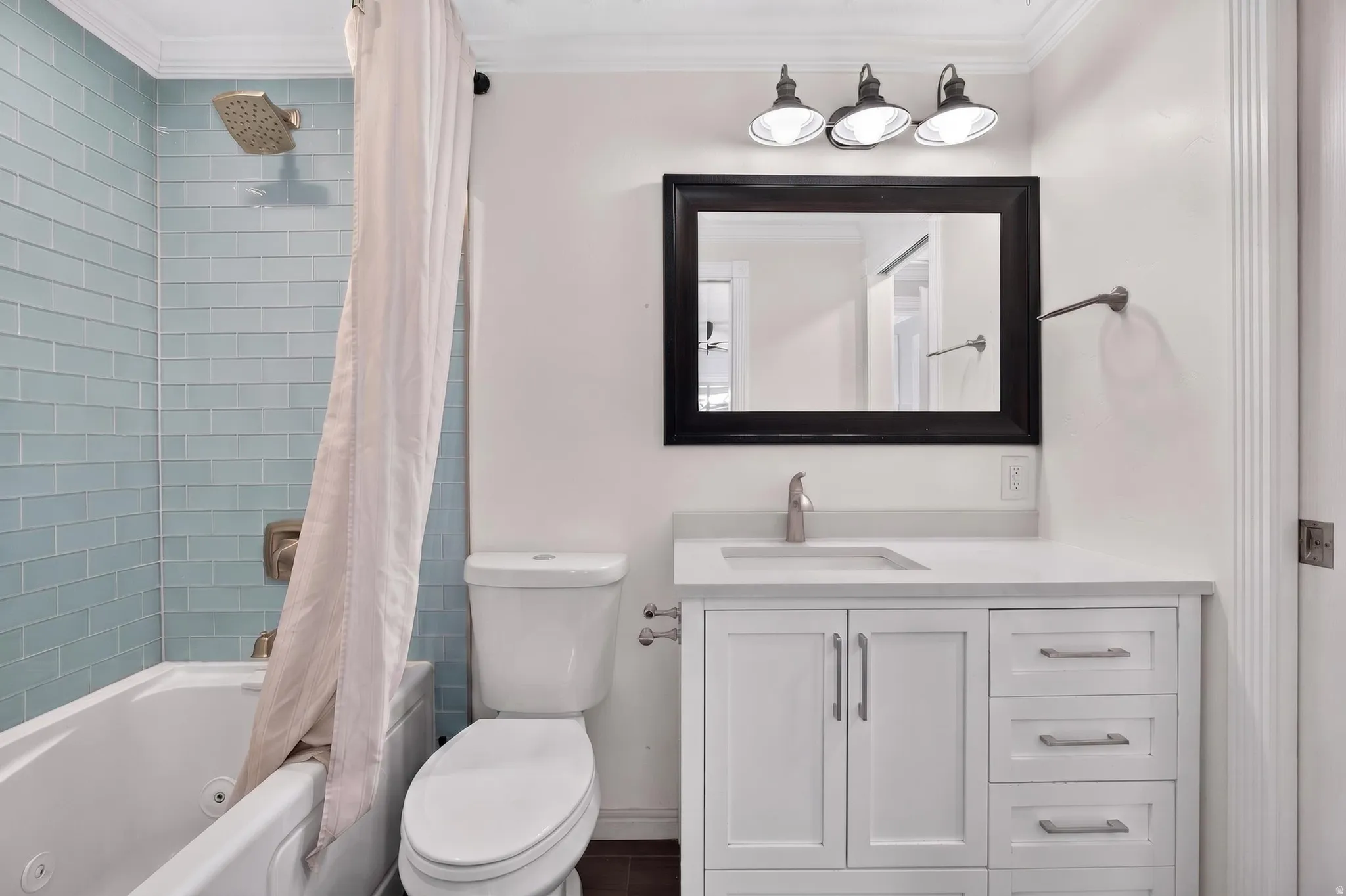 Bathroom vanity featuring a light countertop, integrated sink, and white cabinetry with brushed nickel hardware