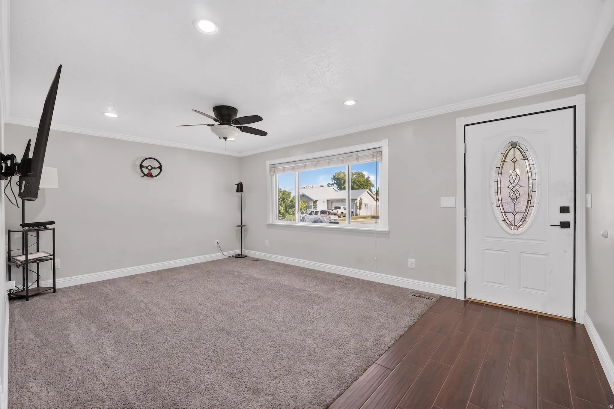 Entryway featuring a decorative glass panel door and wood-finish flooring