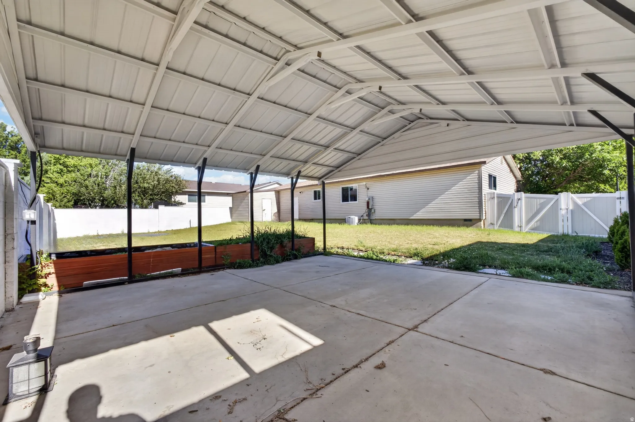 Expansive covered carport with a concrete slab foundation
