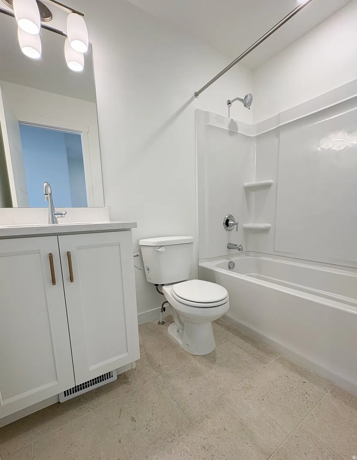Bathroom featuring a white vanity with hardware, a rectangular undermount sink, and a mirrored medicine cabinet