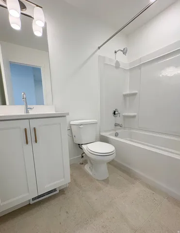 Bathroom featuring a white vanity with hardware, a rectangular undermount sink, and a mirrored medicine cabinet