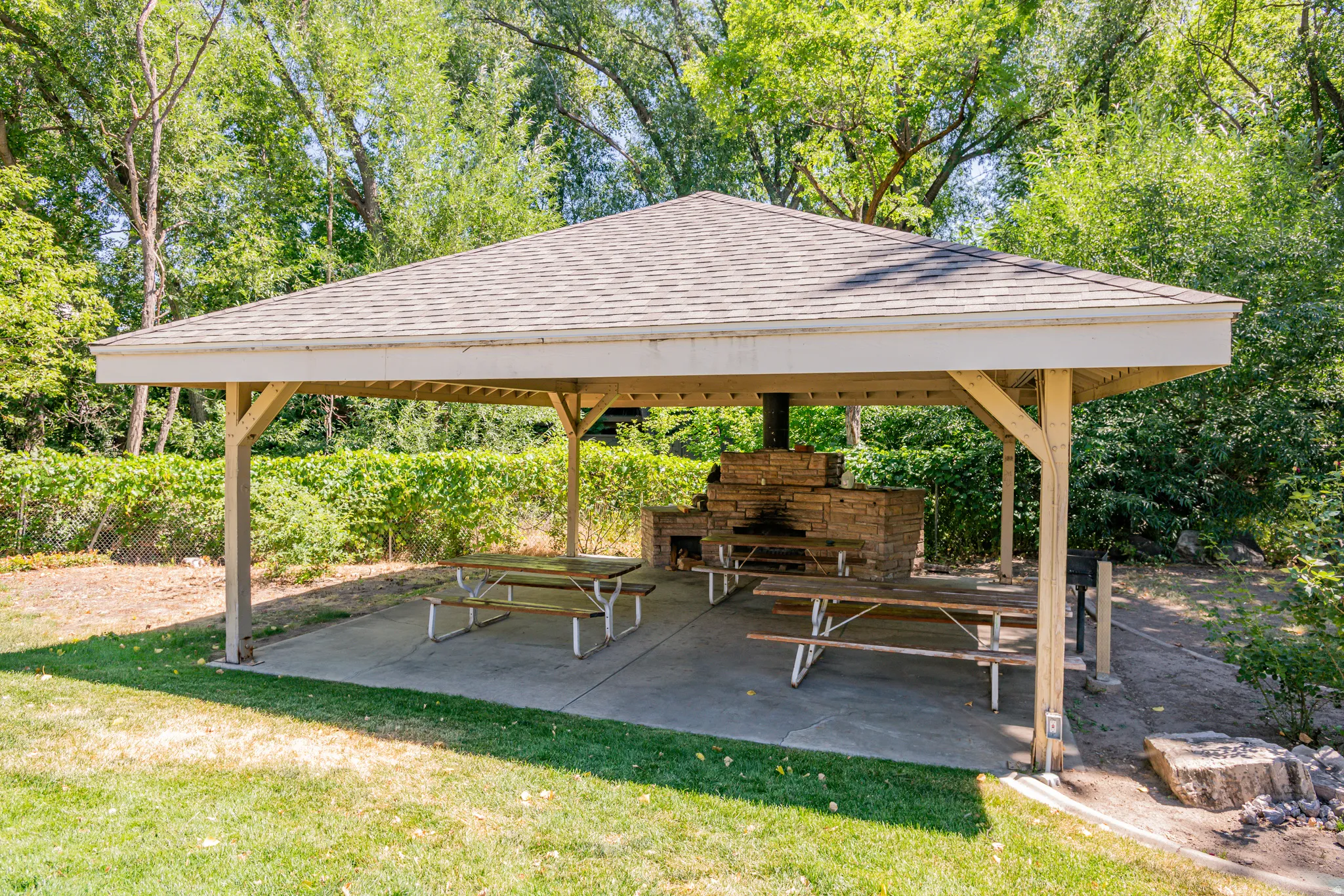 Covered patio featuring a shingled roof and wood support beams