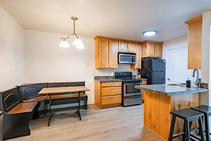 Kitchen featuring wood-finish cabinetry and gray granite-finish countertops