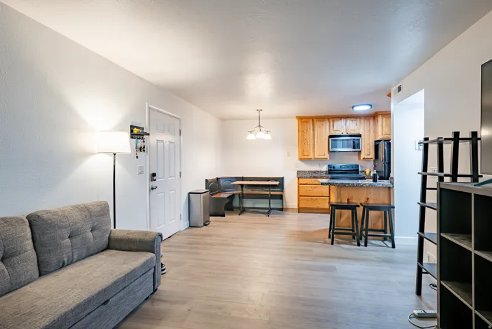 Open-concept living area featuring light wood-finish flooring