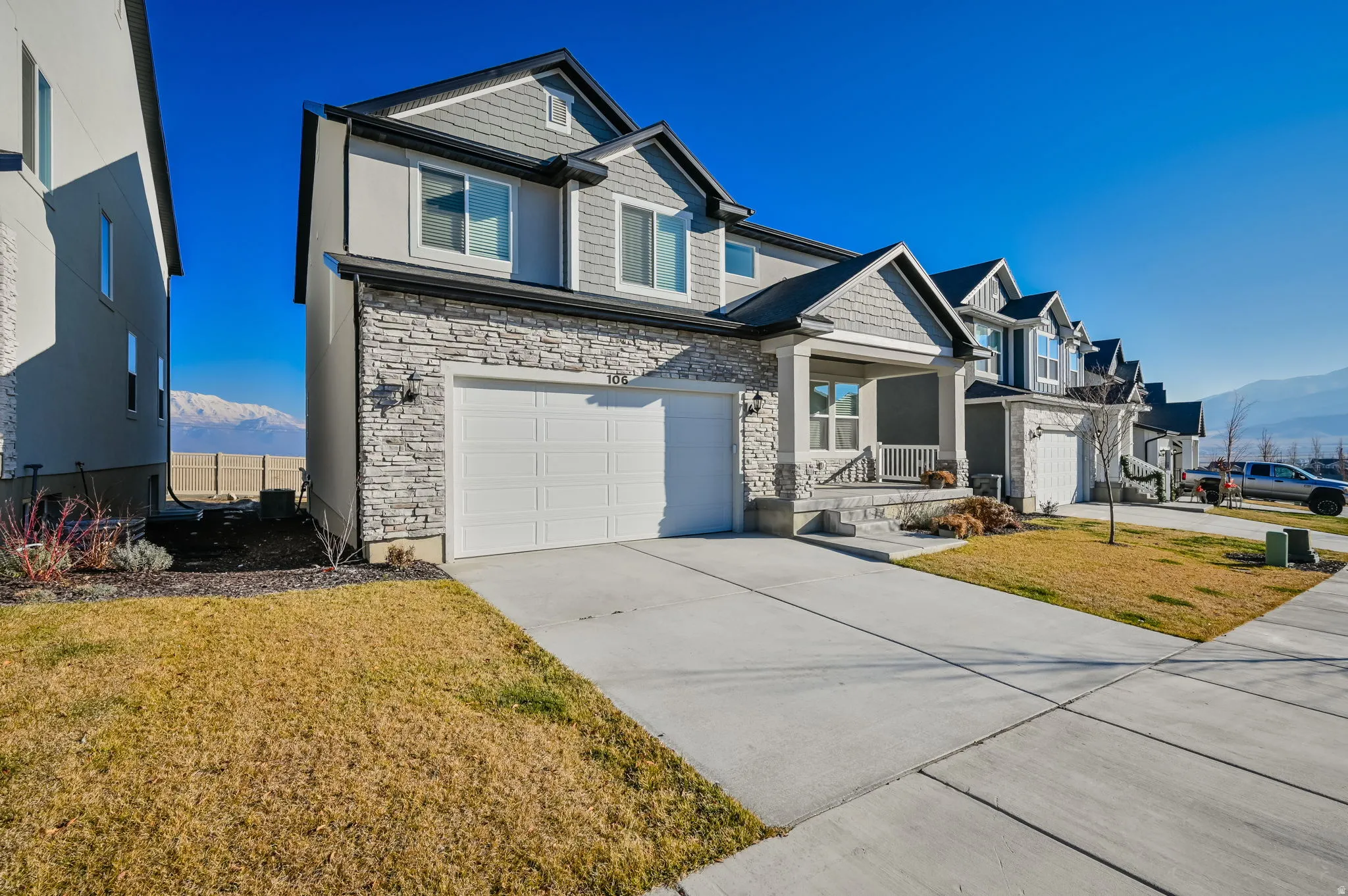 Contemporary two-story residence featuring a stone and siding facade