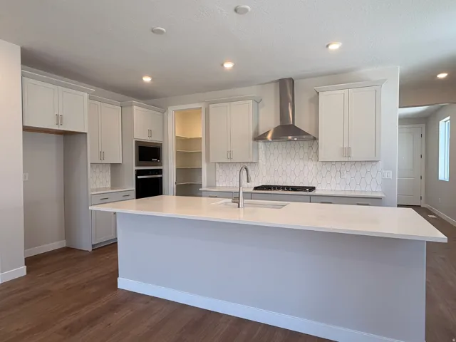 Modern kitchen featuring a large central island with a solid surface countertop