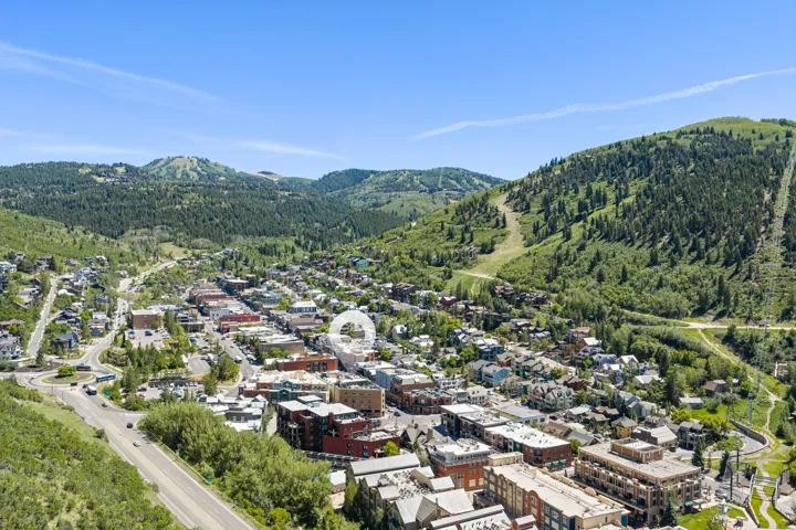 Aerial perspective showcasing a vibrant townscape nestled within mountainous terrain