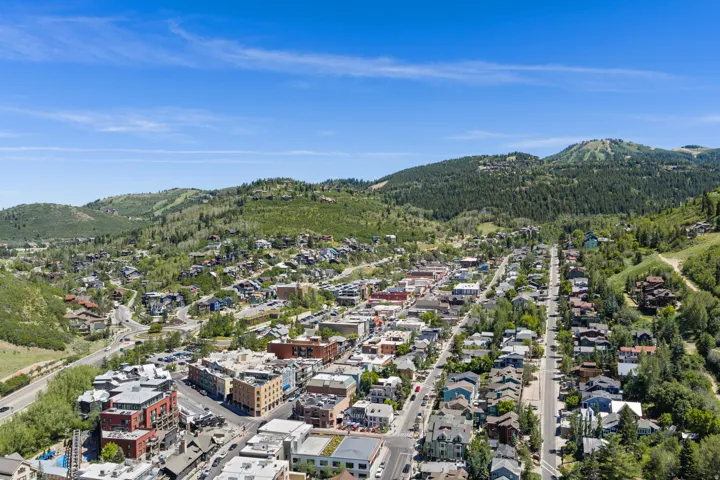 Aerial perspective showcasing a vibrant community nestled among forested hills