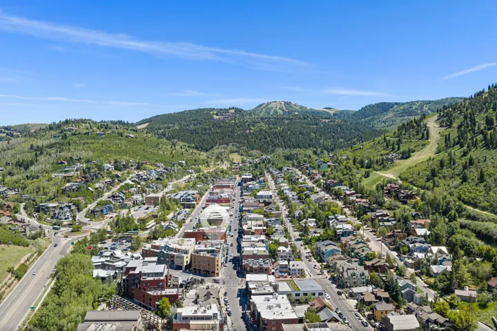 Aerial perspective showcasing a vibrant community nestled within mountainous terrain