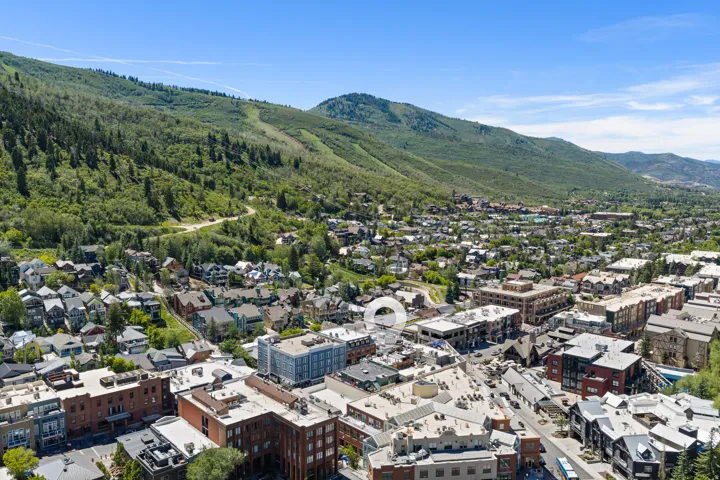 Elevated aerial perspective showcasing a vibrant community nestled among verdant mountains