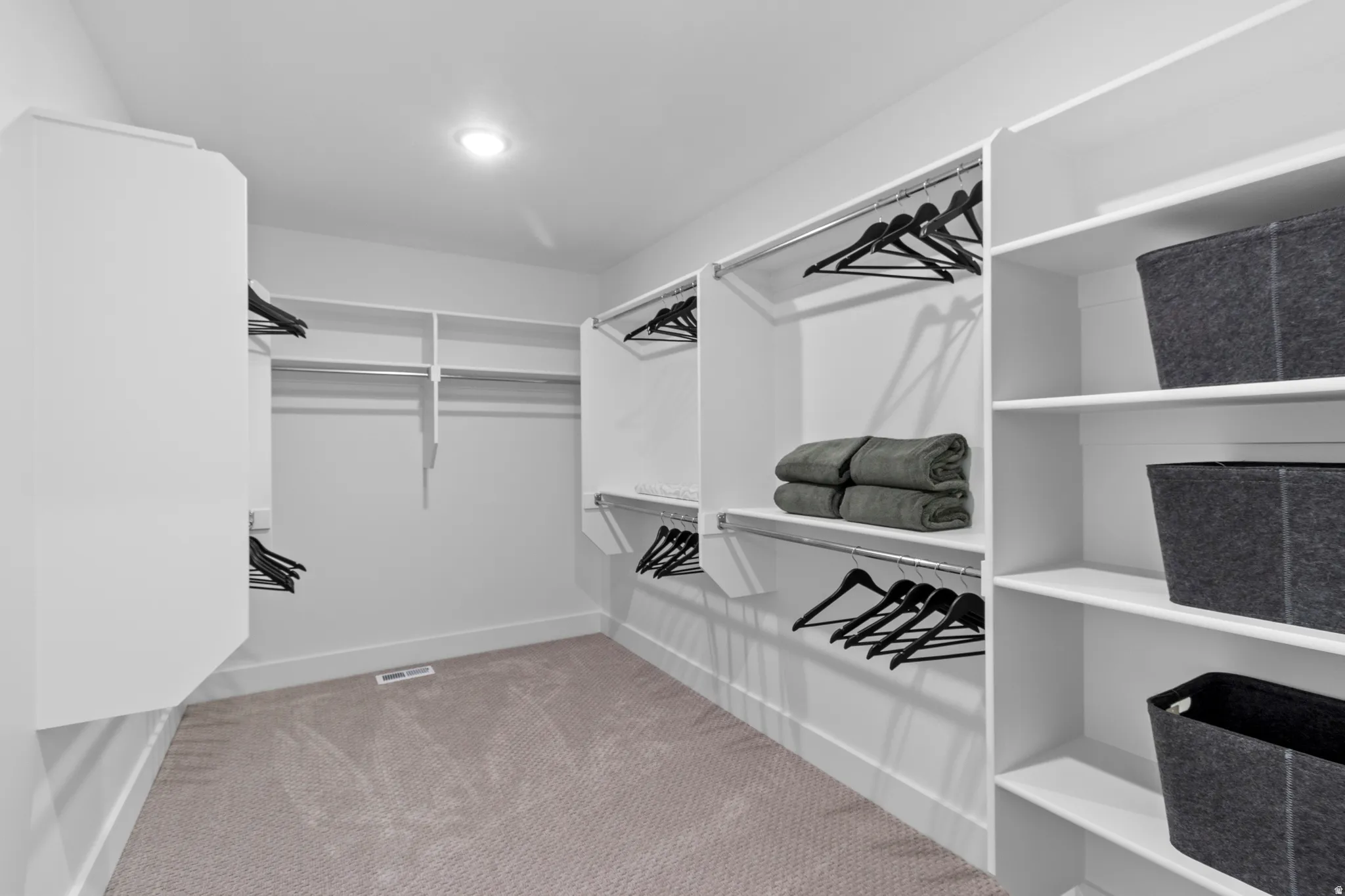 PRIMARY SUITE-SPACIOUS WALK IN CLOSET! (PICTURE IS FROM A PREVIOUS HOME...COLORS AND FINISHES MAY BE DIFFERENT)