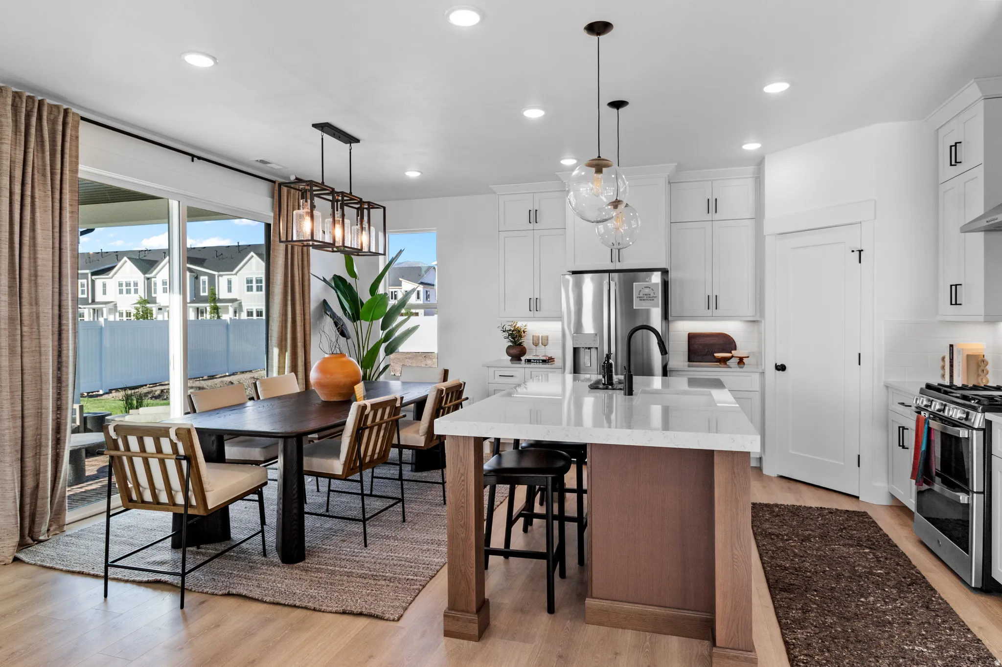 Open-concept kitchen and dining area (PICTURE IS FROM A PREVIOUS HOME...COLORS AND FINISHES MAY BE DIFFERENT)