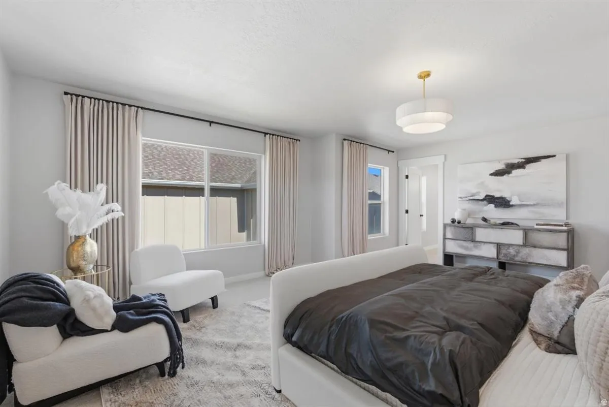 Spacious room featuring multiple windows, neutral wall tones, and a tiered drum pendant light fixture