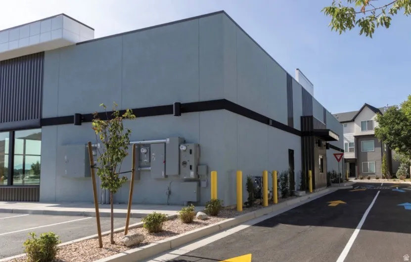 Contemporary commercial building featuring a smooth stucco exterior with black accent bands