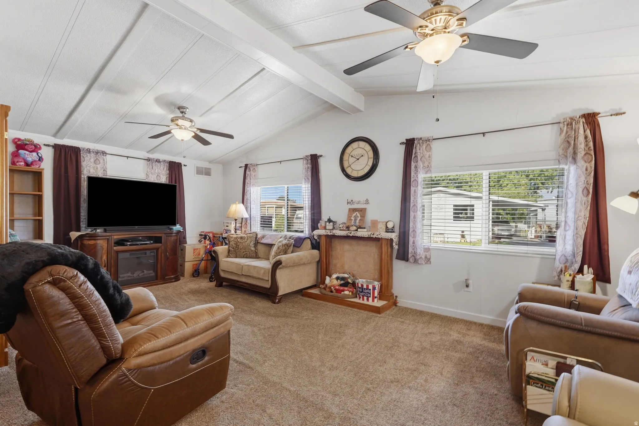 Living area with vaulted ceiling and exposed white beams
