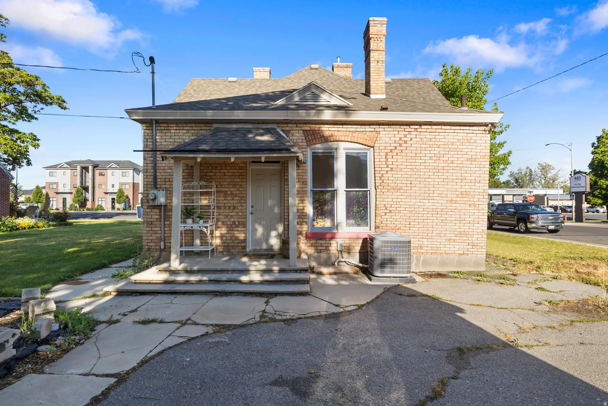 Brick exterior with a covered front porch and arched window details