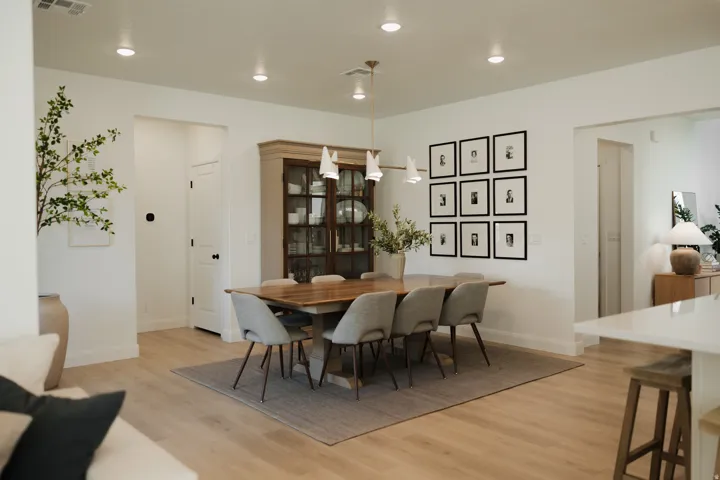 Open-concept dining area featuring light wood-finish flooring and recessed lighting
