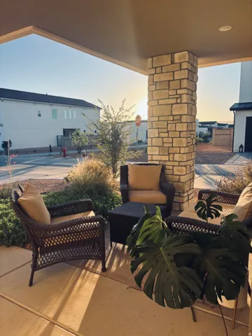 Front porch with a stone-clad pillar and recessed lighting