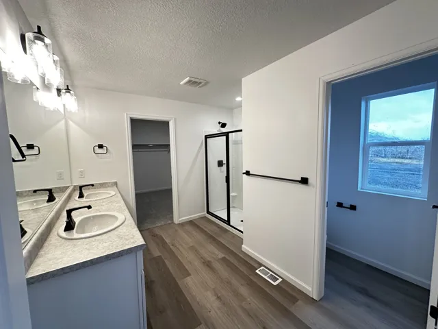 Dual vanity with undermount sinks and dark-finish faucets