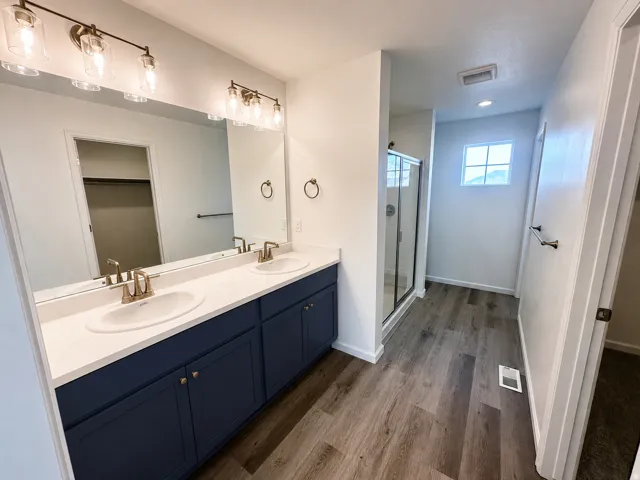 Dual sink vanity with white countertop and blue cabinetry