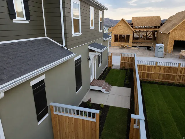 Exterior featuring multi-toned siding, white trim, and dark shutters