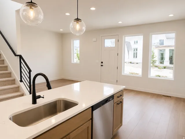 Kitchen island featuring a stainless steel undermount sink and matte black faucet