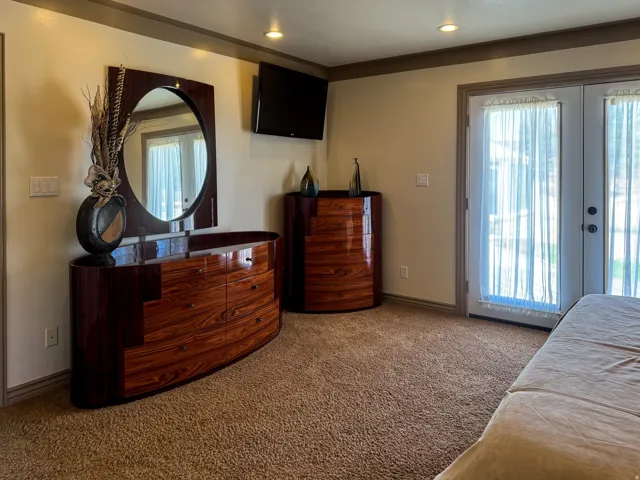 Recessed ceiling lighting, crown molding, and neutral wall tones
