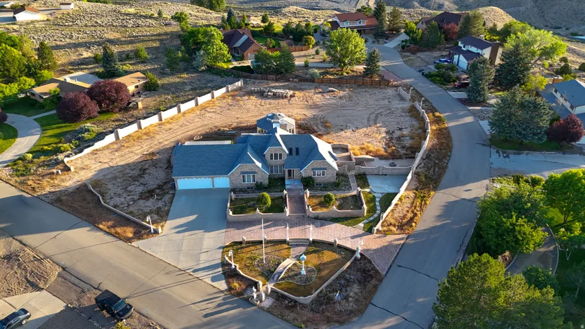 Stone-clad residence featuring a multi-gabled roofline and an attached two-car garage