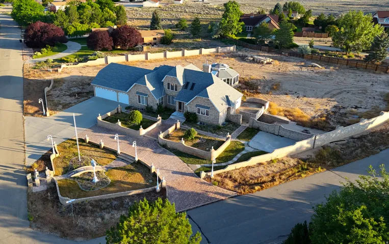 Stone-clad exterior featuring multiple gables and a sunroom extension