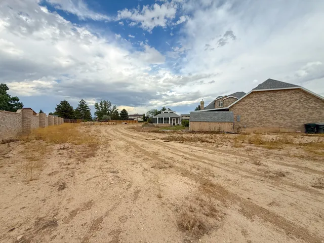 Expansive cleared lot featuring level ground and partial perimeter fencing
