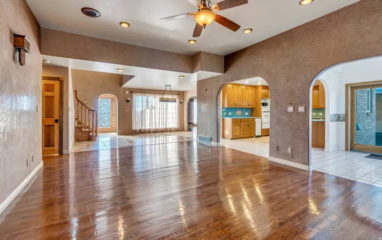 Expansive main living area featuring wood-finish flooring, recessed lighting, and a ceiling fan