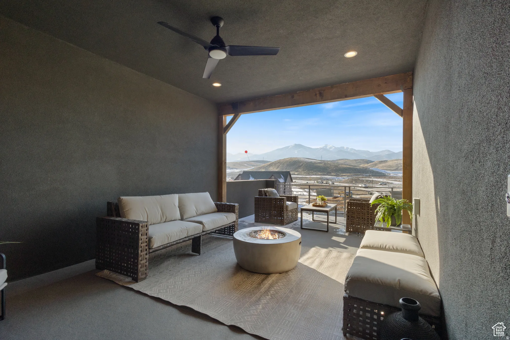 Covered patio featuring exposed wood beams, recessed lighting, and a ceiling fan