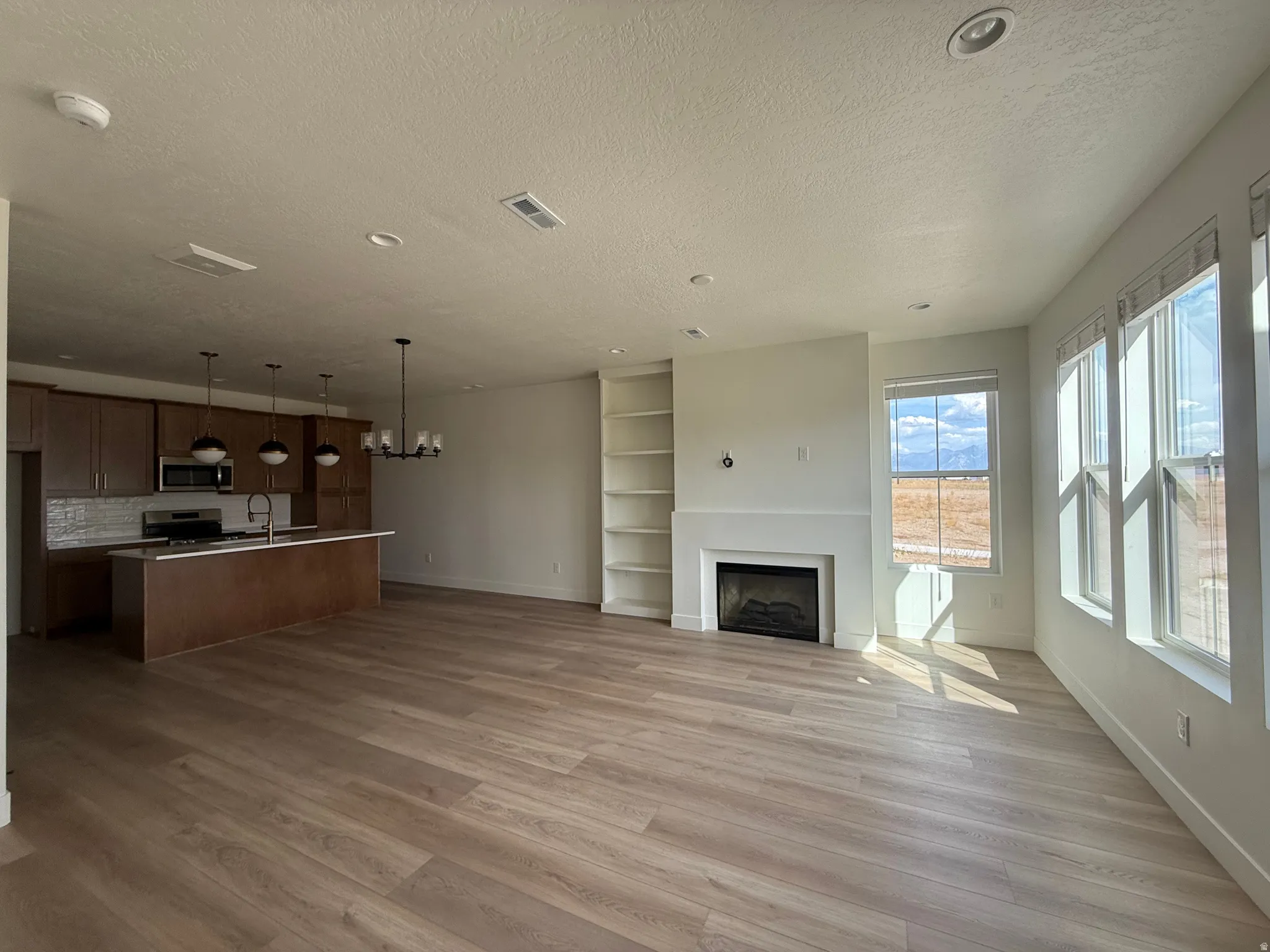 Open-concept living space featuring wood-finish flooring