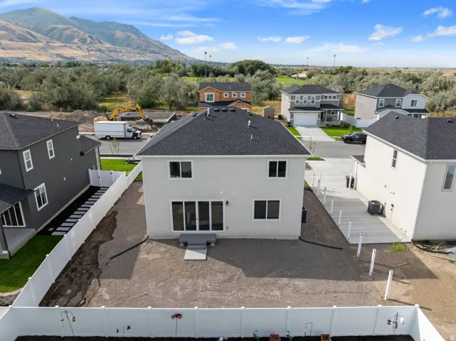 Contemporary stucco exterior with a dark asphalt shingle roof