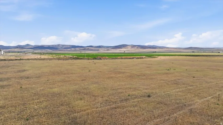 Expansive open land with a distant mountain range backdrop