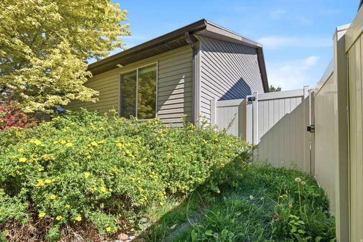 Exterior siding and a private gate define this property boundary