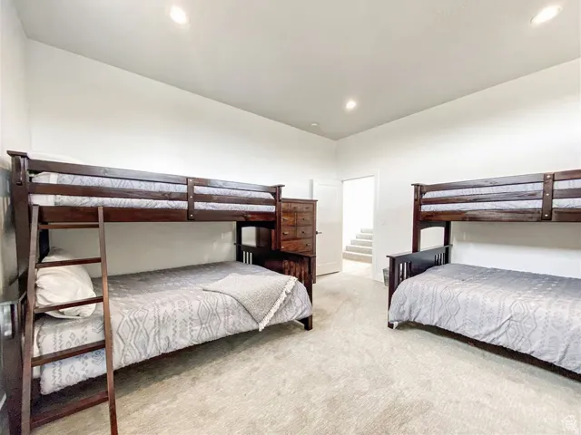 Carpeted room with recessed lighting and neutral wall tones