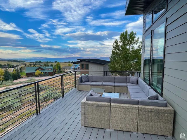 Expansive outdoor deck featuring wood-finish composite decking and modern cable railings