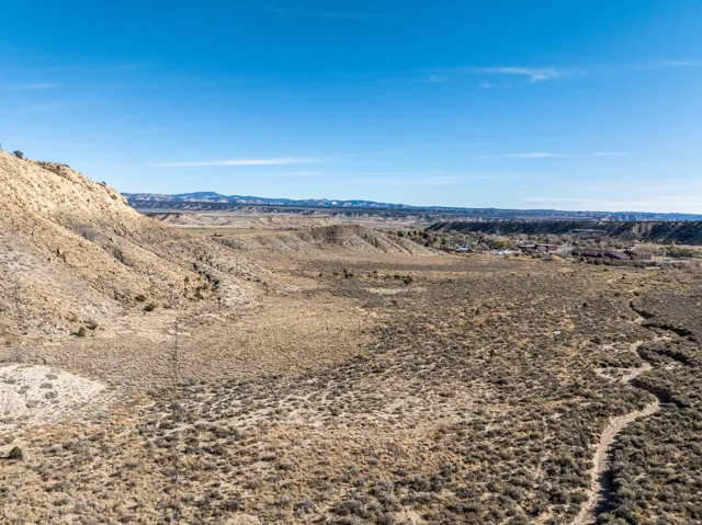 Expansive undeveloped land featuring a varied topography of rolling hills and flat plains