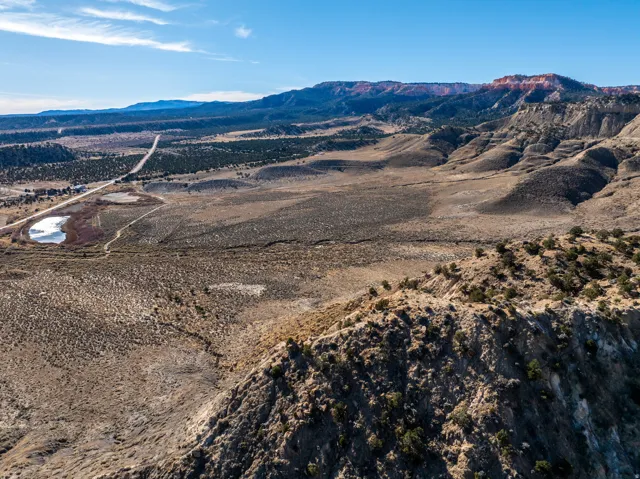 Expansive desert landscape featuring rugged terrain and distant mountain ranges