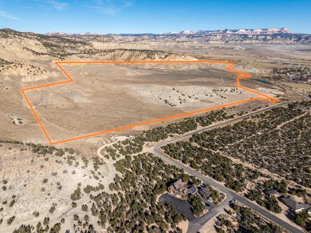 Expansive undeveloped land outlined in orange, featuring varied terrain and natural vegetation