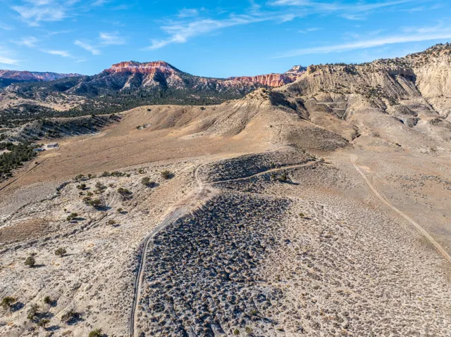 Expansive undeveloped land featuring diverse desert terrain and distant red rock formations