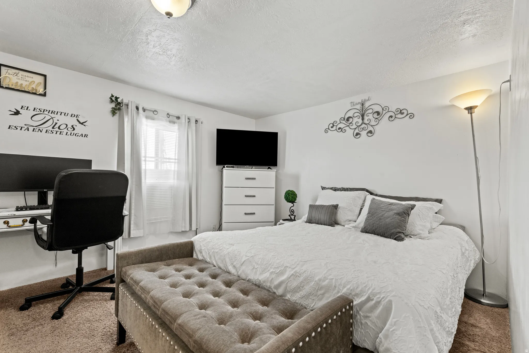 Bedroom featuring light-colored walls and soft brown carpet flooring
