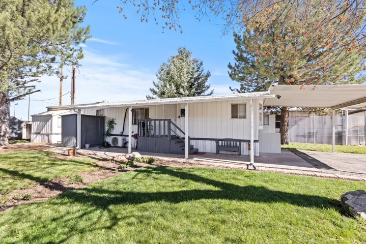 White exterior with dark gray trim and white porch roof